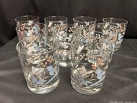 Front view of nine Noritake Kilkee tumblers showing butterfly and floral motif