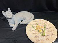 Cat statue and floral plaque overview