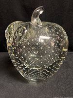 Front view of clear glass apple showing controlled bubbles and stem