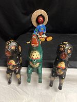 front view of two dogs, crocodile, marionette in background