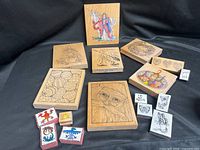 Group shot of all fifteen stamps arranged on black cloth