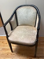 Front view of chair showing upholstery, frame and nailhead trim