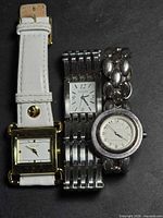 Front view of three Ecclissi wristwatches side by side