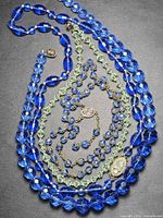 All three necklaces coiled to show bead colors, shapes and clasps
