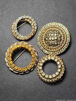 All four circular brooches front view