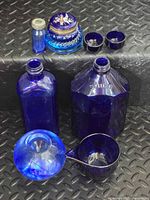All eight cobalt glass items grouped