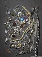 Full spread of assorted necklaces, bracelets, brooches, pendants and charms