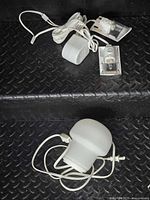 Pendant lamp and Ikea clip track light with cords arranged on black step surface