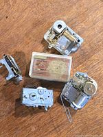 Group of five music box movements on wood surface