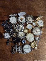 Group shot of entire assortment of pocket watches and chains