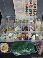 Overall lot showing acrylic box with rocks and three large mineral specimens