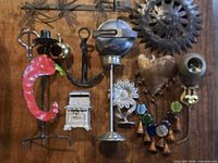 Full grouping of assorted metal decor pieces on wood backdrop