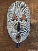 Front view of carved wooden Kifwebe mask showing pattern and features