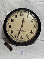 Front view of Hammond Postal Telegraph wall clock showing dial and power cord