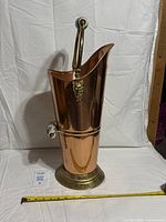 Full view of copper scuttle showing height and brass base