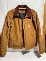 Front view of brown duck Carhartt chore coat with corduroy collar