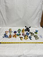 All 19 Pokémon figures laid out with ruler for scale