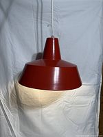 Front view of red enamel pendant lamp showing shape and color