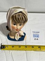 Front view of Relpo teen girl head vase with measuring tape for scale