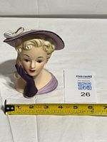 Front view of Relpo lady head vase with measuring tape