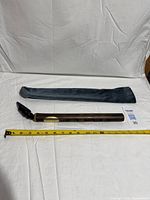 Complete bamboo saxophone with mouthpiece, sleeve and tape measure for scale