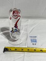 Full view of glass sculpture on white background, tape measure showing length
