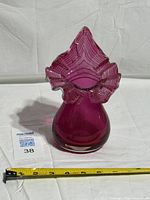 Front view of cranberry art glass vase