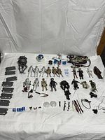 Group shot of all action figures, vehicle, stands and accessories