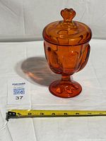 Full view of amberina pedestal candy jar with lid