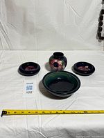 Group shot of vase, large bowl, two shallow dishes with tape for scale