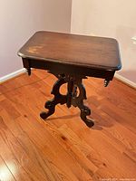 Full view of side table showing top, pedestal and feet