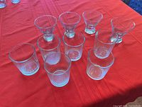 Group shot displaying all 10 glasses: 4 martini and 6 ribbed tumblers on red tablecloth