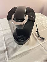 Front view of Keurig coffeemaker with reservoir and drip tray