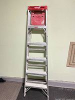 Full view of 6' Werner aluminum stepladder standing upright