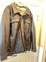 Front view of Levi's black bomber jacket on hanger