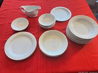 All eighteen white dishes displayed on table