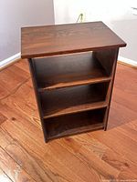 Front view showing three tiers and wood grain