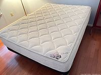 Queen Euro-top mattress on box spring and frame