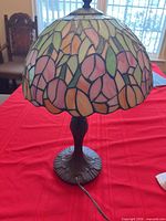 Assembled lamp lit view showing shade pattern and base