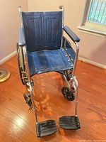 Front view of Invacare Tracer EX wheelchair showing blue seat, chrome frame and footrests