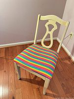 Front angled view showing full chair, wood frame and striped upholstery