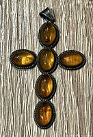 Front view showing six oval amber cabochons, silver rope bezels and bail