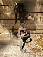Side view of full pump showing handle, spout, flange and pipe