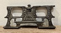 Overall view of cast iron Champion jointer/raker gauge showing shape, lettering, screw, and patina