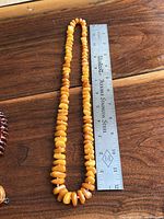 Full view of necklace beside ruler to show length and bead style