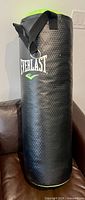 Full view of the Everlast Everstrike punching bag standing upright on couch