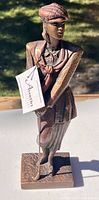Front three-quarter view of golfer figurine showing pose, attire, club and base