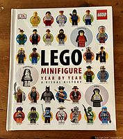 Front cover of hardcover reference book with LEGO minifigure illustrations