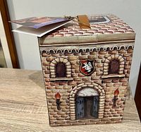 Front and top of castle-shaped box with printed stone design and arched entrance