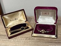 Both wristwatches in their presentation boxes